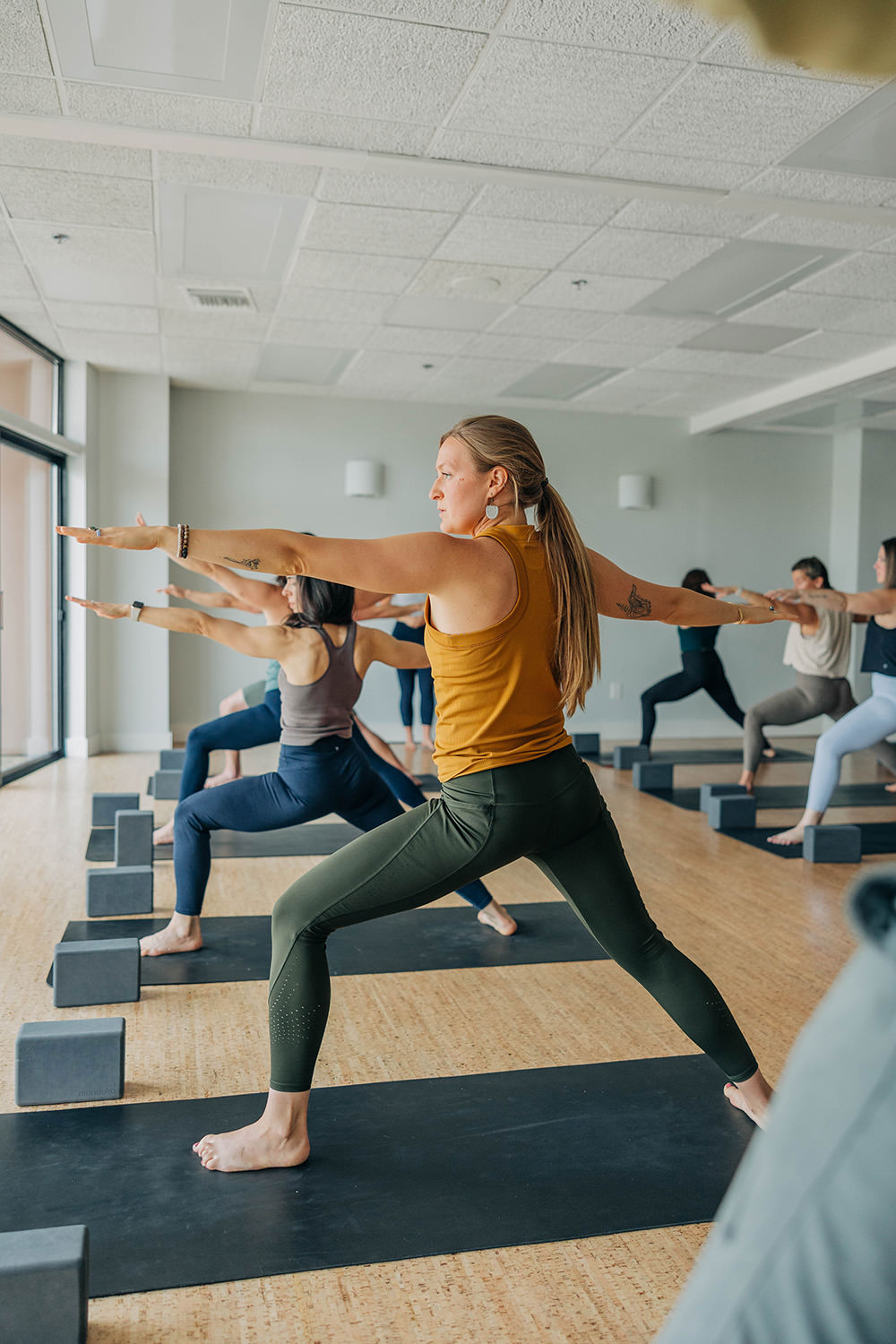 Dharamsala TC Yoga on Front in Traverse City warrior 2 pose